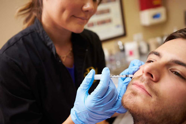 Woman Injecting Into Man